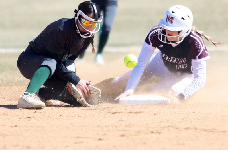 Marengo’s Kylee Jensen pulls in safely at second base as North Boone’s Abby Galarza tries to get a handle on the ball in varsity softball at Marengo High School in Marengo on Saturday, March 22, 2025.