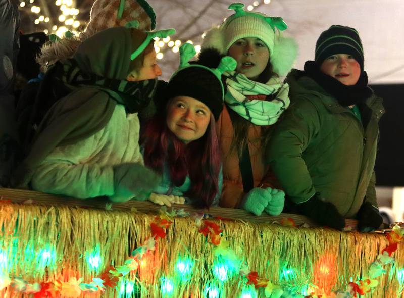 Youngsters look out from a Crystal Lake Park District float during the Festival of Lights Holiday Parade in downtown Crystal Lake on Friday, Nov. 29, 2024.