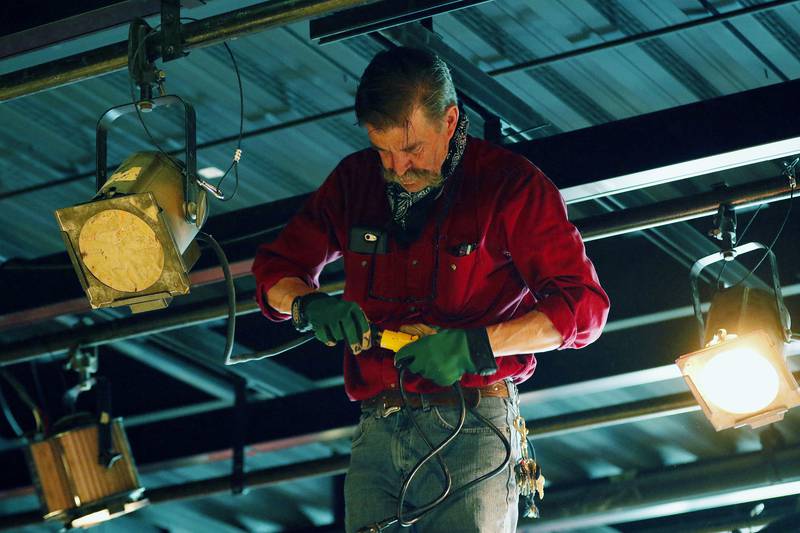 Woodstock Opera House production manager Joe McCormack works on installing stage lighting above the new stage at Stage Left Cafe on Wednesday, April 28, 2021 in Woodstock.