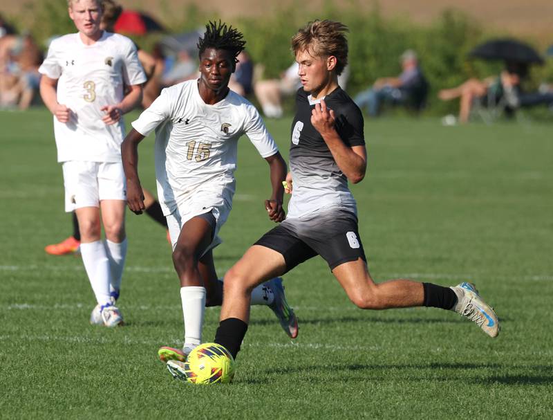 Kaneland's Noah McKittrick (right) tries to kick the ball away from Sycamore's Noah Carlson during their game Wednesday, Sept. 16, 2025, at Kaneland High School in Maple Park.