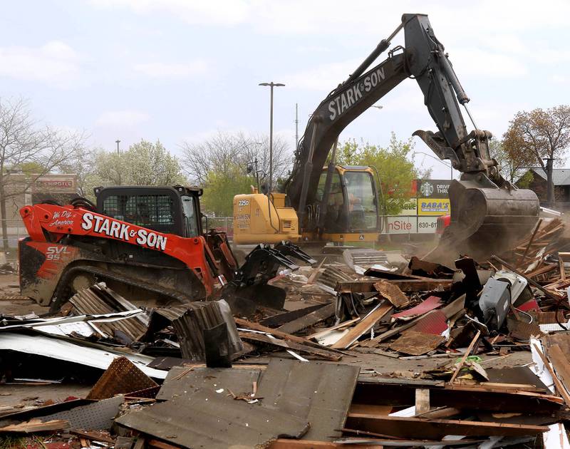 Workers from Stark & Son clean up debris Monday, April 28, 2025, after the former Illini Tire Co. building on the northeast corner West Lincoln Highway and Annie Glidden Road was torn down.