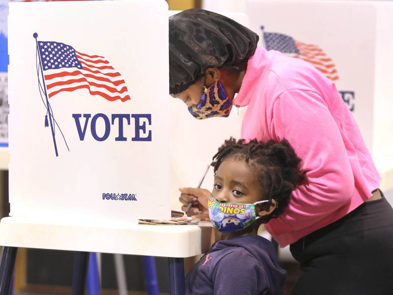 Brianna Brown, from DeKalb, votes with her son J'Breon, 5, at her side Nov. 3 at the polling place inside the Westminster Presbyterian Church on Annie Glidden Road in DeKalb.
