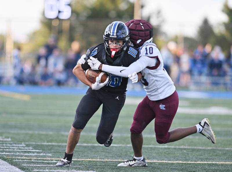Lincoln Way East's Jayden Cawthon (10) gets tackled by Kankakee's Caden Benson (10) during the non-conference game on Friday, Sept. 05, 2025, at Frankfort.