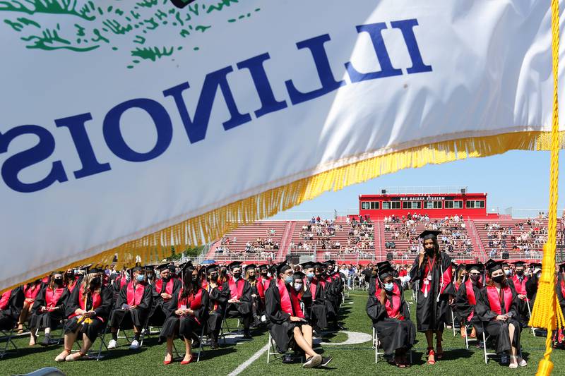 Gianna Tatone heads up to the podium to speak for the senior class presentation during graduation ceremonies Saturday, May 22, 2021, at Huntley High School in Huntley.  The school graduated 736 students over three Saturday ceremonies.