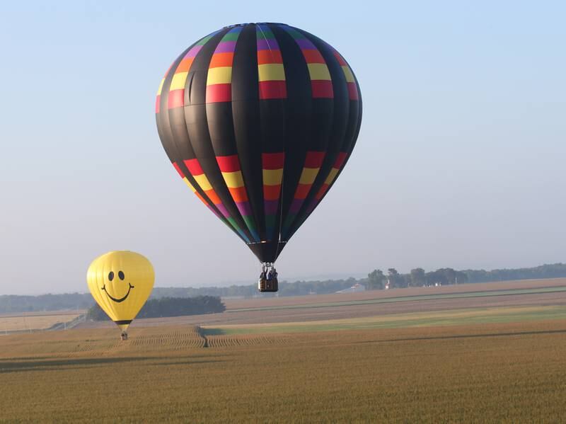 Hot air balloons fly over farm fields during the 52nd annual Homestead Festival on Saturday, Sept. 9, 2023 in Princeton.