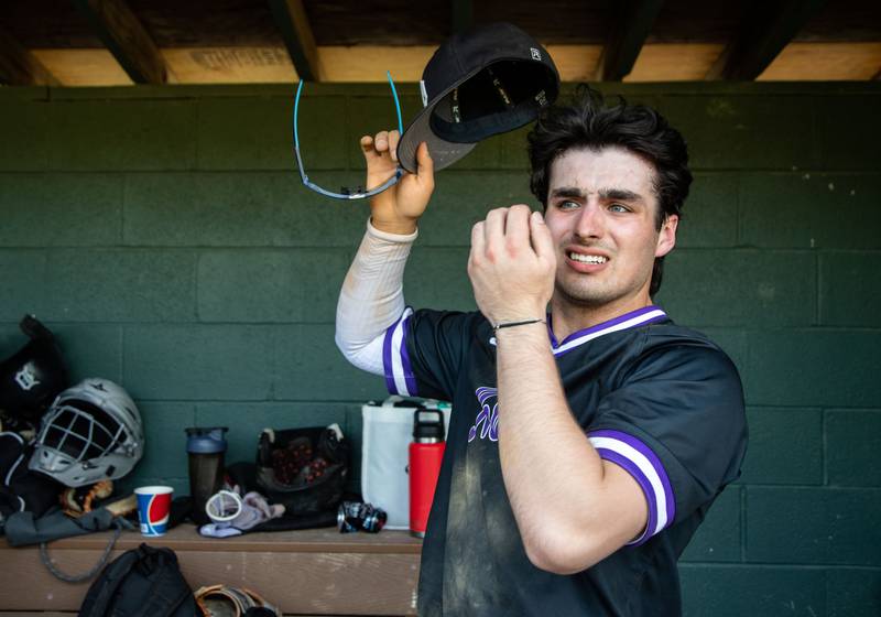 Downers Grove North’s JD Cumbee fixes his hat before heading onto the field during a game against Lyons Township in Downers Grove on Monday, May 12, 2025.