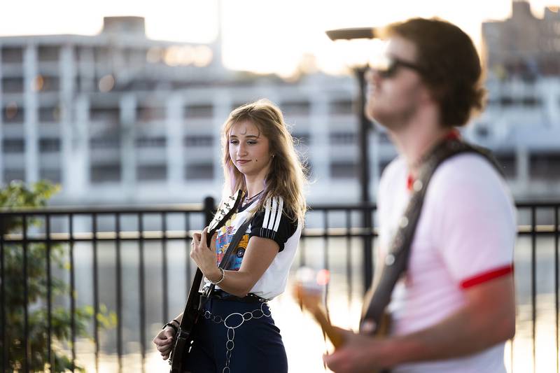 Eva Dillon of local rock band The Solution, plays the guitar  Thursday, June 19, 2025, during the Rock Falls Block Party. The band played on the stage at RB&W Park as the burnout show came to a close.