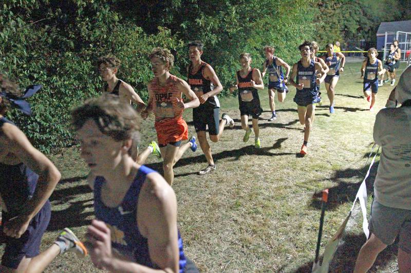 Varsity boys compete in the Naperville North Twilight Cross Country Invitational on Wednesday, Oct. 9, 2024 in Naperville.