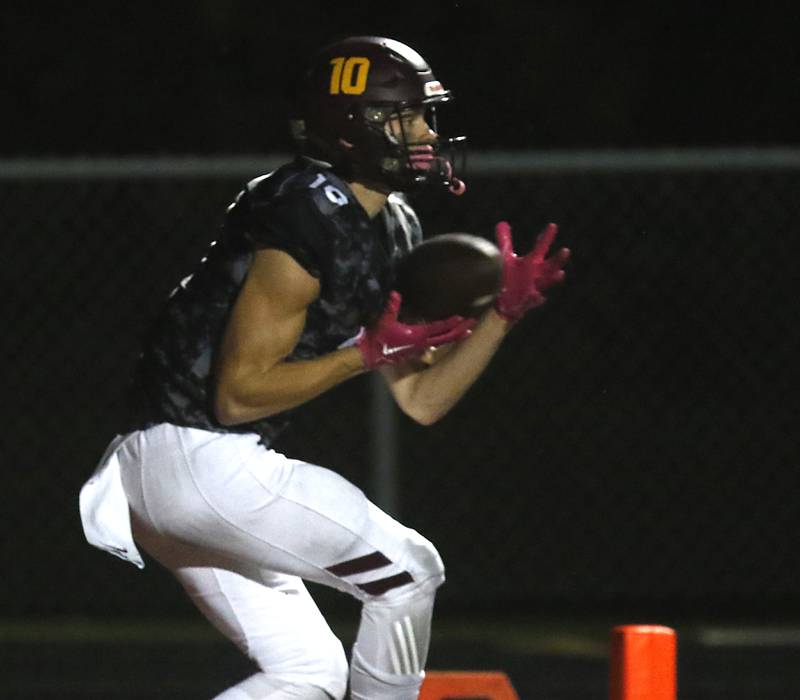 Richmond-Burton's Max Loveall catches a touchdown pass during a Kishwaukee River Conference football game against Harvard on Thursday, Oct.12, 2023, at Richmond-Burton High School.