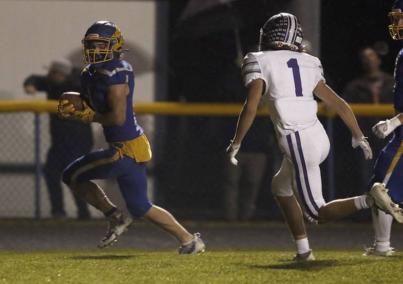 Johnsburg's Jake Metze runs away from Rochelle's Grant Gensler to score a touchdown during a IHSA Class 4A second round playoff football game Friday, Nov. 4, 2022, between Johnsburg and Rochelle at Johnsburg High School in Johnsburg.