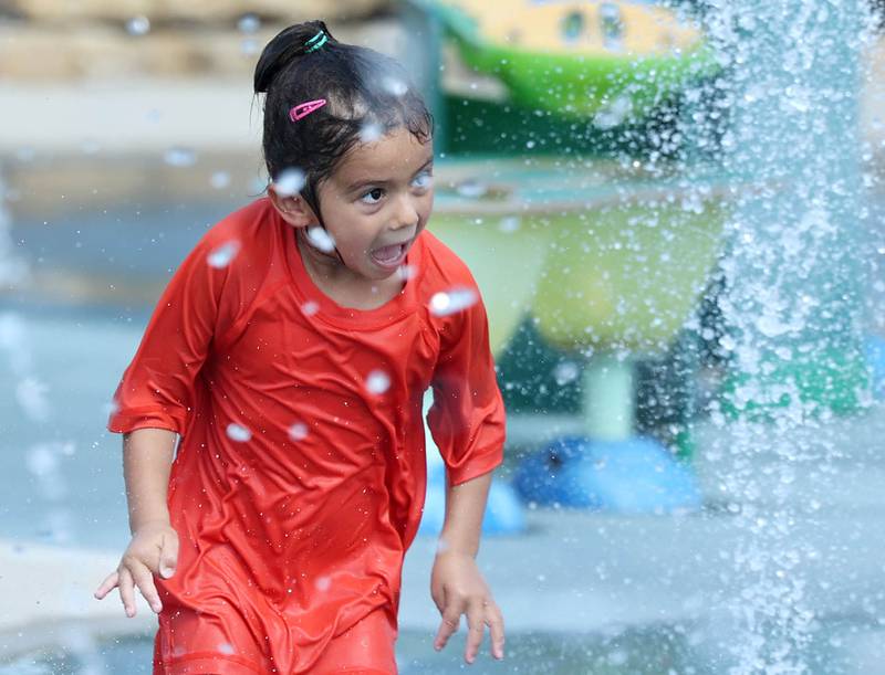 Anna Swanson, 5, who is in Sycamore visiting her grandparents from Madison Wis., keeps cool Wednesday, Aug. 23, 2023, by playing in the Sycamore Park District Splash Fountain splash pad. Temperatures climbed into the high 90’s Wednesday with more hot weather expected Thursday.