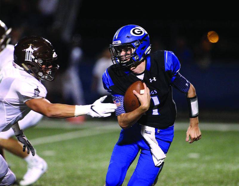 Geneva quarterback Bobby Murray runs the ball Aug. 25 during a home game against Joliet Catholic at Burgess Field. Murray rushed for 76 yards and passed for 260 in a 34-27 loss that saw a big comeback fall short.