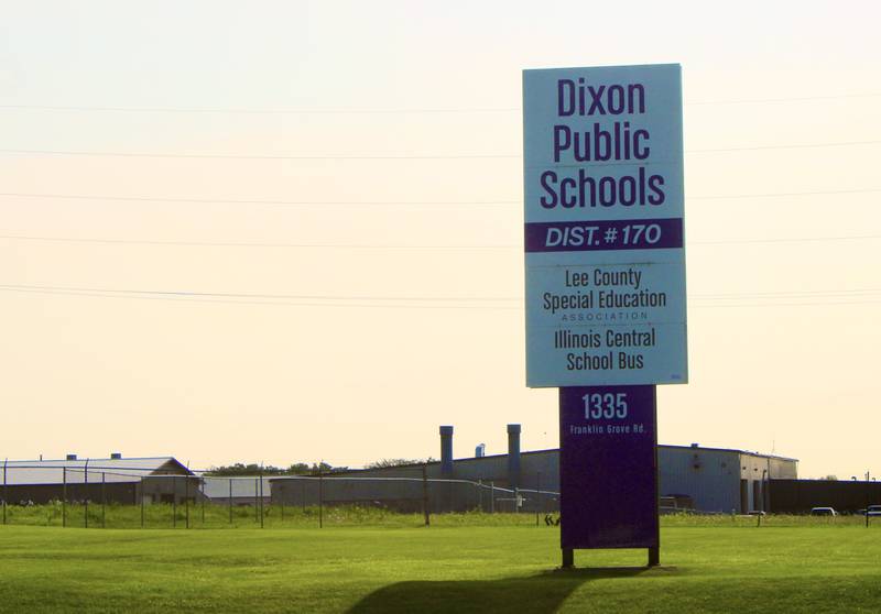 An August sun rises behind the Dixon Public Schools road sign indicating the Franklin Grove Road district offices in Dixon.