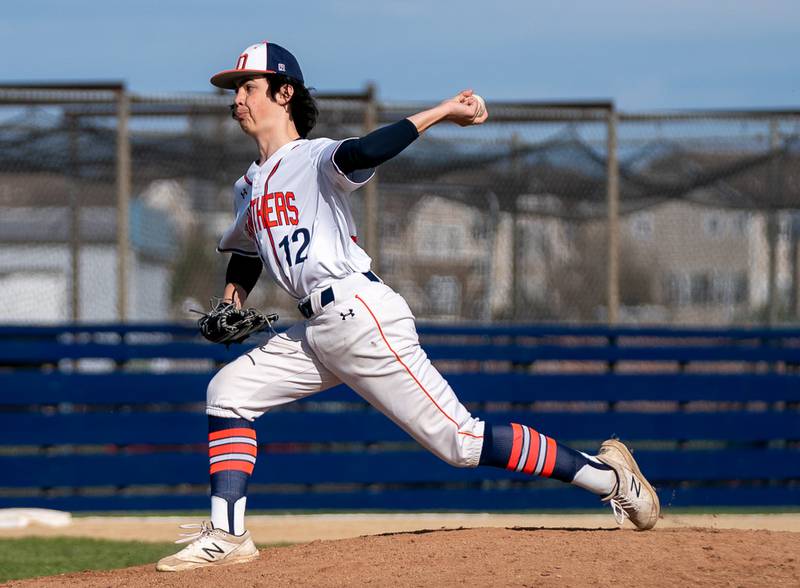 Oswego’s Bryson Mello (12) delivers a pitch against Plainfield South during a baseball game at Oswego High School on Monday, April 11, 2022.