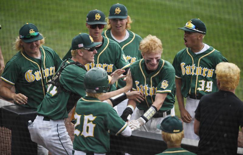 Crystal Lake South’s Ryan Skwarek is greeted at the dugout after scoring the first run against Fenwick in the 3A supersectional baseball game at Wintrust Field in Schaumburg on Monday, June 6, 2022.
