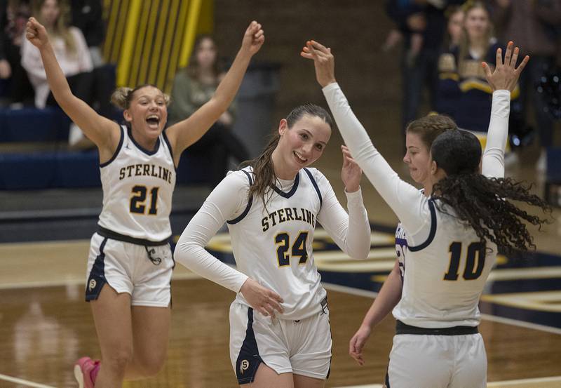 Teammates celebrate Sterling’s Madison Austin after sinking a free throw for her 1,000 career point Monday, Feb. 17, 2025, in a semifinal regional against Rochelle.