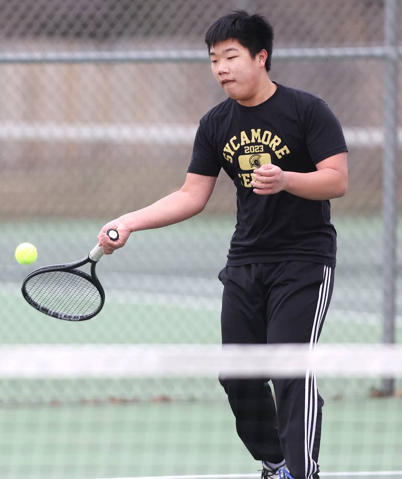 Sycamore’s Regan Ni hits a forehand during his number two singles match against Dixon Thursday, March 30, 2023, at Sycamore High School. This is the inaugural season for the Sycamore boys tennis team.