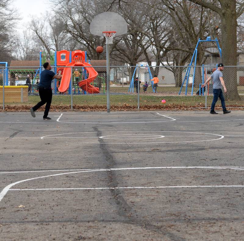 Two men shoot some hoops at the basketball court at Vaile Park in Dixon on Thursday, Feb. 8, 2024. The Dixon Park District has received a state grant to improve the court.