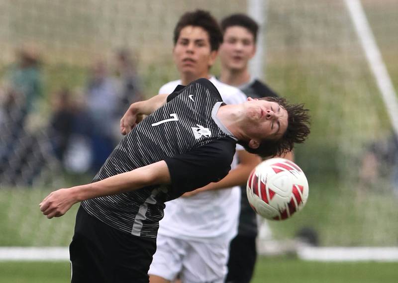 Kaneland's Cameron Guernon tries to head the ball in front of a Sycamore player during their game Wednesday, Sept. 6, 2023, at Kaneland High School in Maple Park.