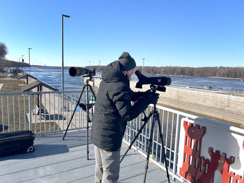 Paul Winer, one of the hosts and naturalists at Lock & Dam 13, north of Fulton, watches bald eagles through a spotting scope from the observation deck during the 40th Annual Bald Eagle Watch on Saturday, Feb. 17, 2024.