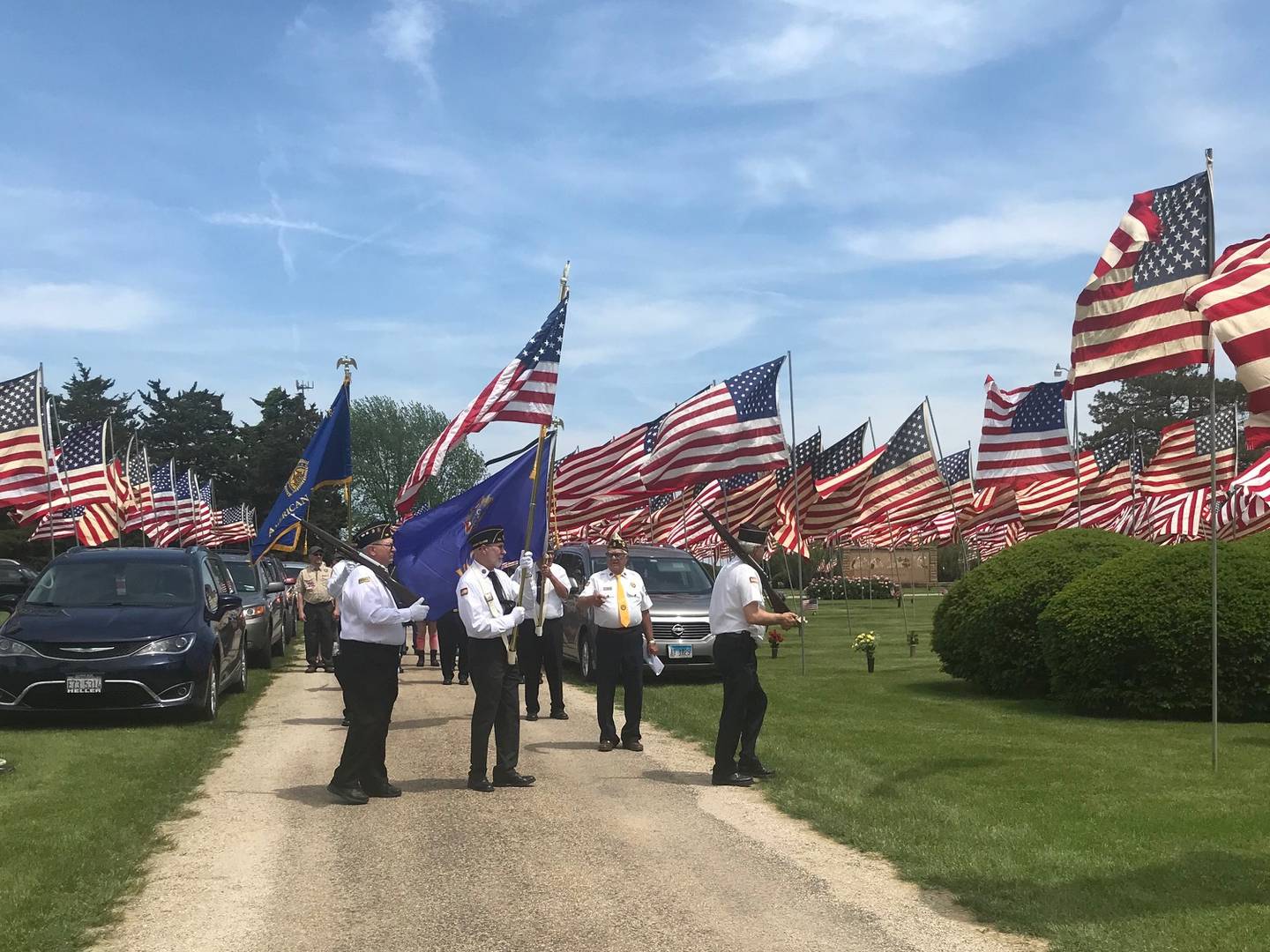 Veterans groups march into Valley Memorial Park along the "Avenue of Flags" Monday for Memorial Day services. The avenue contained 469 flags for veterans interred there, 13 of whom were killed in action.