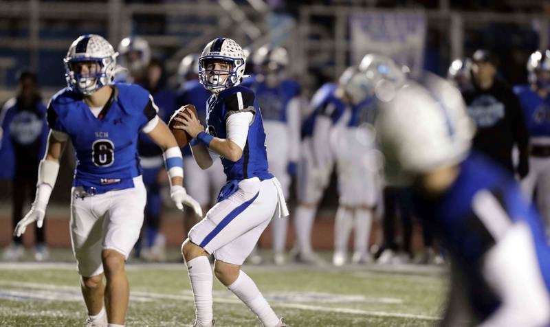 St. Charles North's Will Vaske (12) looks for an open receiver Friday October 28, 2022 in St. Charles.