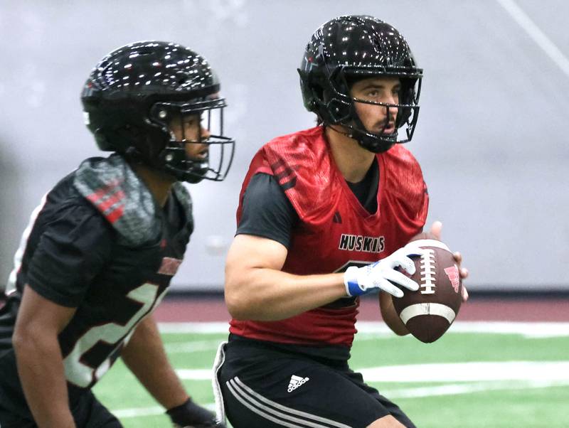 Northern Illinois University quarterback Ethan Hampton takes a snap Wednesday, July 31, 2024, during practice in the Chessick Practice Center at NIU.