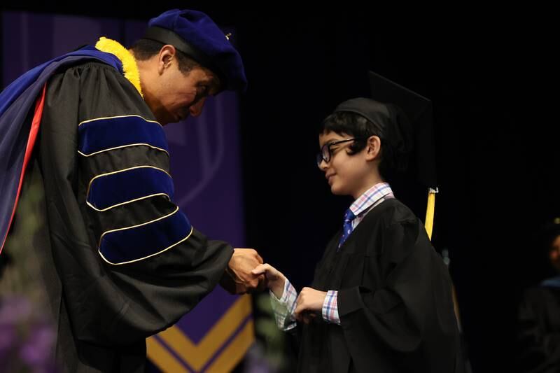 President Dr. Clyne Namuo congratulates Benyamin Bamburc after receiving his Associate in Arts Degree at the Joliet Junior College Commencement Ceremony on Friday, May 19, 2023, in Joliet.