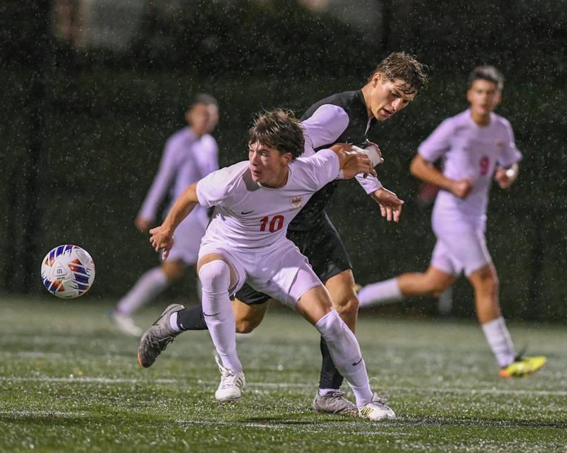Benet Academy's Jack Wesley (10) defends Prairie Ridge's Henry Knoll (9) while trying to control the ball during the class 2A super sectional soccer match on Tuesday Nov. 5, 2024, held at Wheaton Academy in West Chicago.