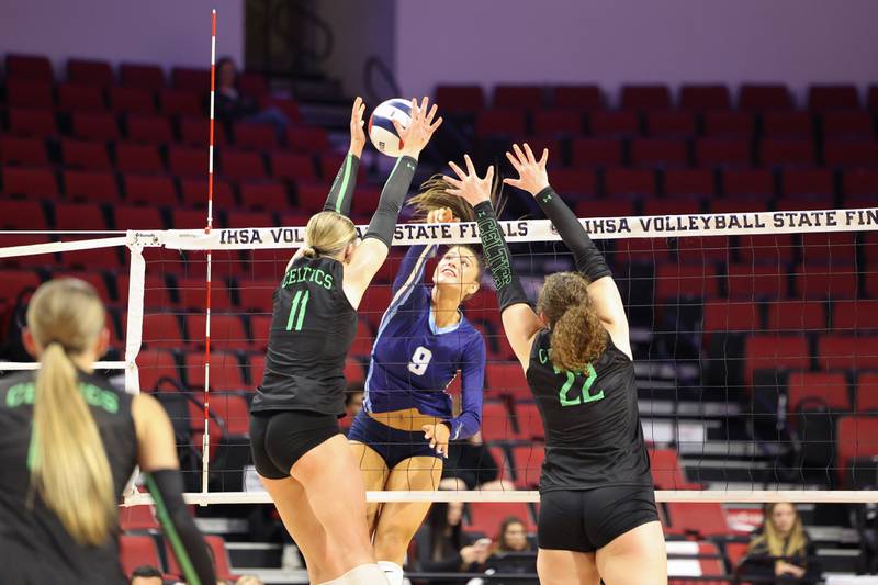 Nazareth's Jane Manecke spikes the ball under pressure from Providence's Abbey Knight, left, and Grace Lustig during Nazareth's victory in two sets, 25-16, 25-17, over Providence in the IHSA Class 3A State semifinals on Friday, Nov. 14, 2025.