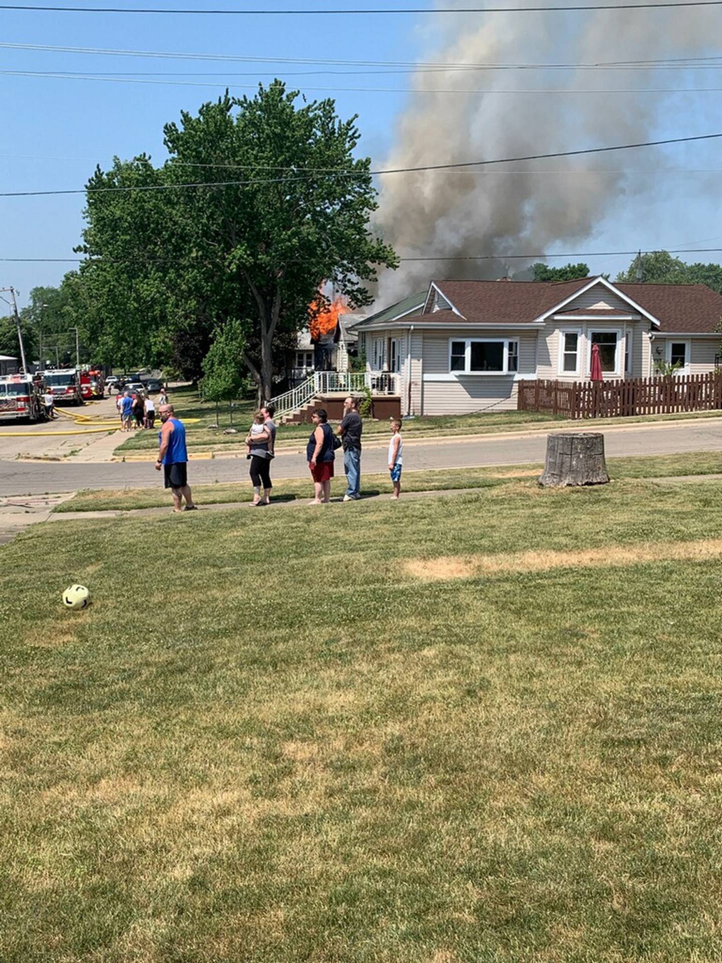 Residents watch as smoke and flames could be seen from a block away of a fire on the 200 block of East Caroline Street in Spring Valley.