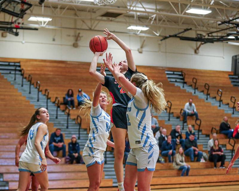 St Charles East's Sofia O’sullivan (21) puts up a contested shot at the York Thanksgiving Tournament. Nov 13, 2023.