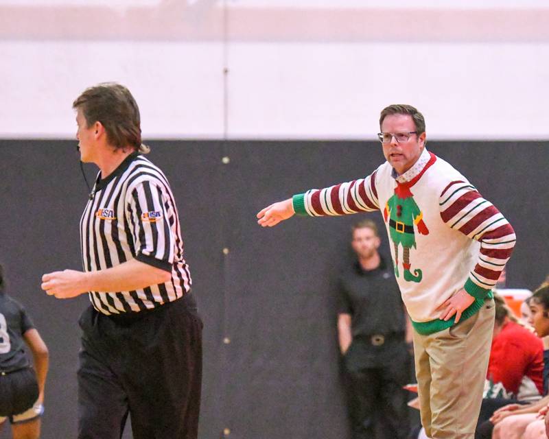 Oswego East's head coach Abe Carretto argues his case with the ref during the game on Thursday Dec. 18, 2025, while traveling to take on Yorkville High School.