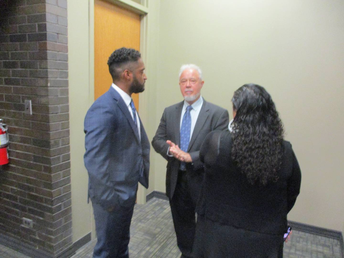 Alfonso Sanchez (left) consults with his attorney Steven Calcaterra (center) after the Joliet Board of Fire and Police Commissioners approved Sanchez's termination from the Joliet Police Department. Aug. 25, 2025