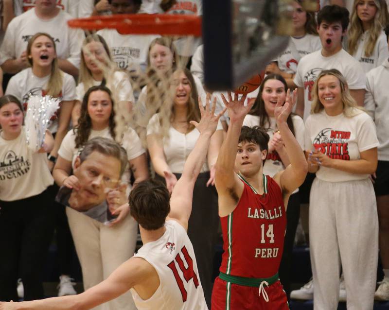 L-P's Brendan Boudreau shoots a jump shot over Metamora's Luke Hopp during the Class 3A Sectional on Tuesday, Feb. 27, 2024 at Pontiac High School.