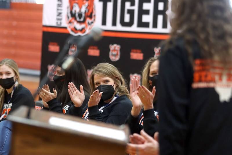 Head Coach Elizabeth Lamb, center, applauds as members of her team speak on Sunday. Crystal Lake Central held a celebration Sunday in their gymnasium after the Tigers on Saturday won the IHSA state title in Competitive Cheerleading-Medium Team at Grossinger Motors Arena in Bloomington.
