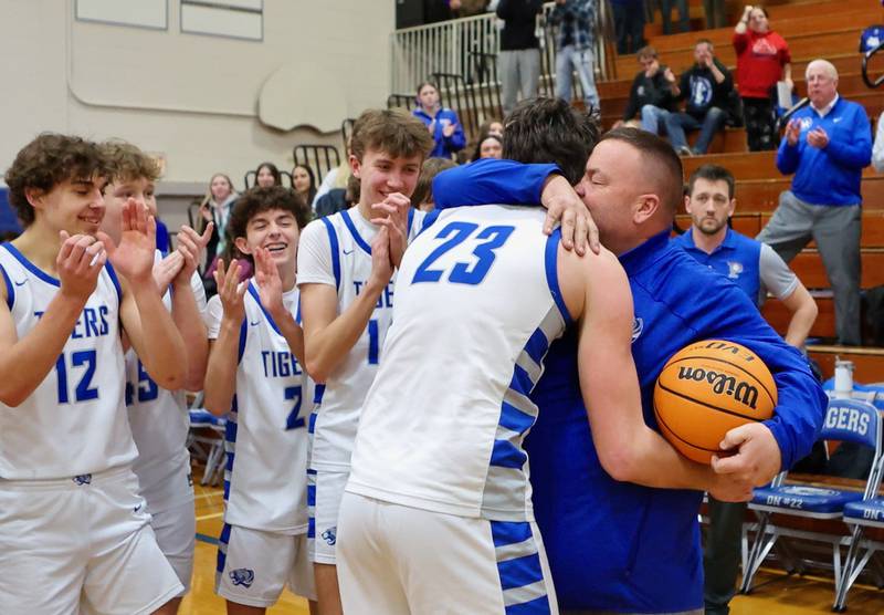 Princeton's Noah LaPorte receives a hug from Tiger coach Jason Smith after breaking the all-time scoring record with 1,470 career points Saturday night at Prouty Gym.