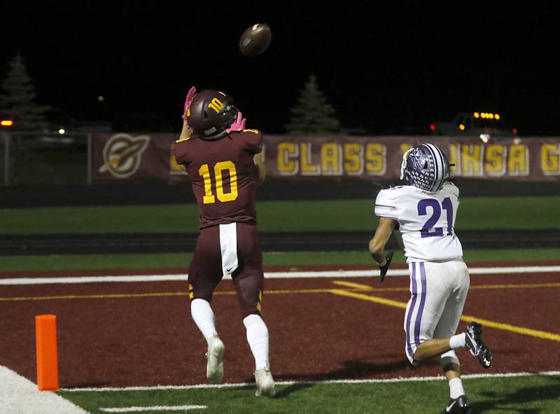 Richmond-Burton's Max Loveall catches a touchdown pass in frontt of Rochelle's Xavier Villalobos during a Kishwaukee River Conference football game on Friday, Oct.20, 2023, at Richmond-Burton High School.