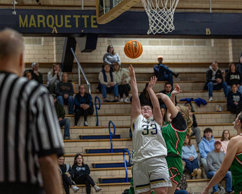 Madison Kozlowski (33) of Marquette lays ball up whilst Lily Morscheiser (33) of LaSalle-Peru attempts to deflect shot on Saturday, January 3, 2026 at Marquette Academy in Ottawa.