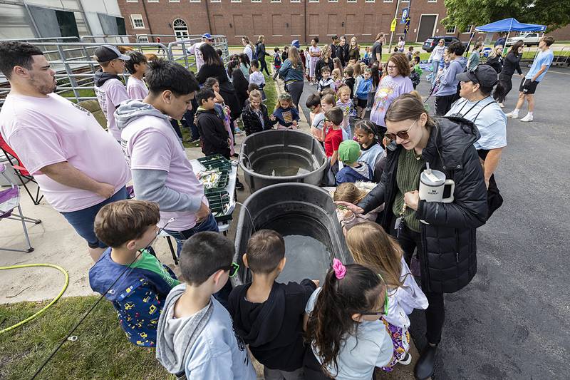 Jefferson School kindergarten teacher Ally Everett (right) helps her class learn about fish at a fishing booth led by SHS FFA students Thursday, May 9, 2024.