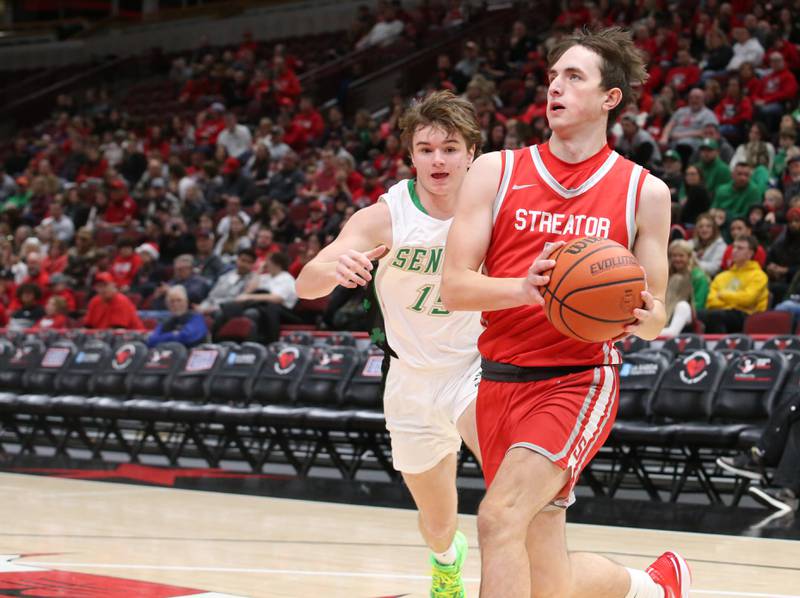 Streator's Alex Kostal eyes the hoop while running past Seneca's Sam Kleich during a game on Tuesday, Dec. 21, 2023 at the United Center in Chicago.