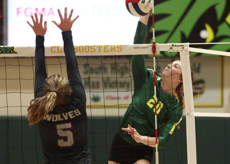 Crystal Lake South’s Morgan Johnson, right, hits the ball as Prairie Ridge’s Grace Jansen blocks in varsity volleyball at Crystal Lake South Tuesday night.