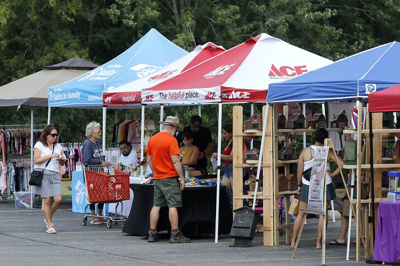 People shop at a Pop Up Market outside of the Laskowski ACE Hardware store, in McHenry, on Friday, Aug.15, 2025, during McHenry.’ 815 Day.
