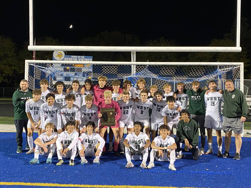 Glenbard West's soccer team poses with its regional championship plaque on Friday.