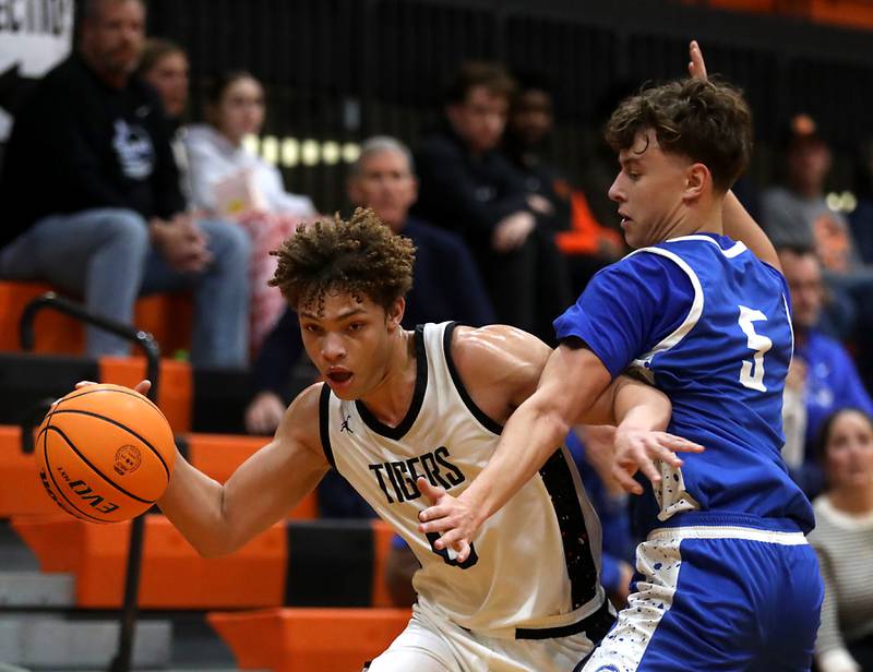 Crystal Lake Central's Avery Lee tries to drive the baseline against Woodstock's Max Beard during a nonconference boys basketball game on Monday Jan. 5,  2026, at Crystal Lake Central School.
