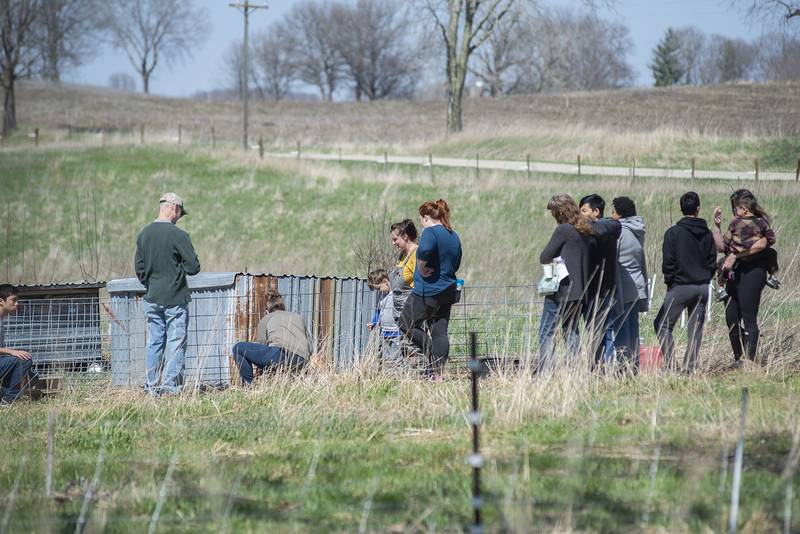 Olson leads a group as they visit the farm Thursday, April 22, 2022 during a foraging class. The students learned about spotting plants and using them for food or medicine.