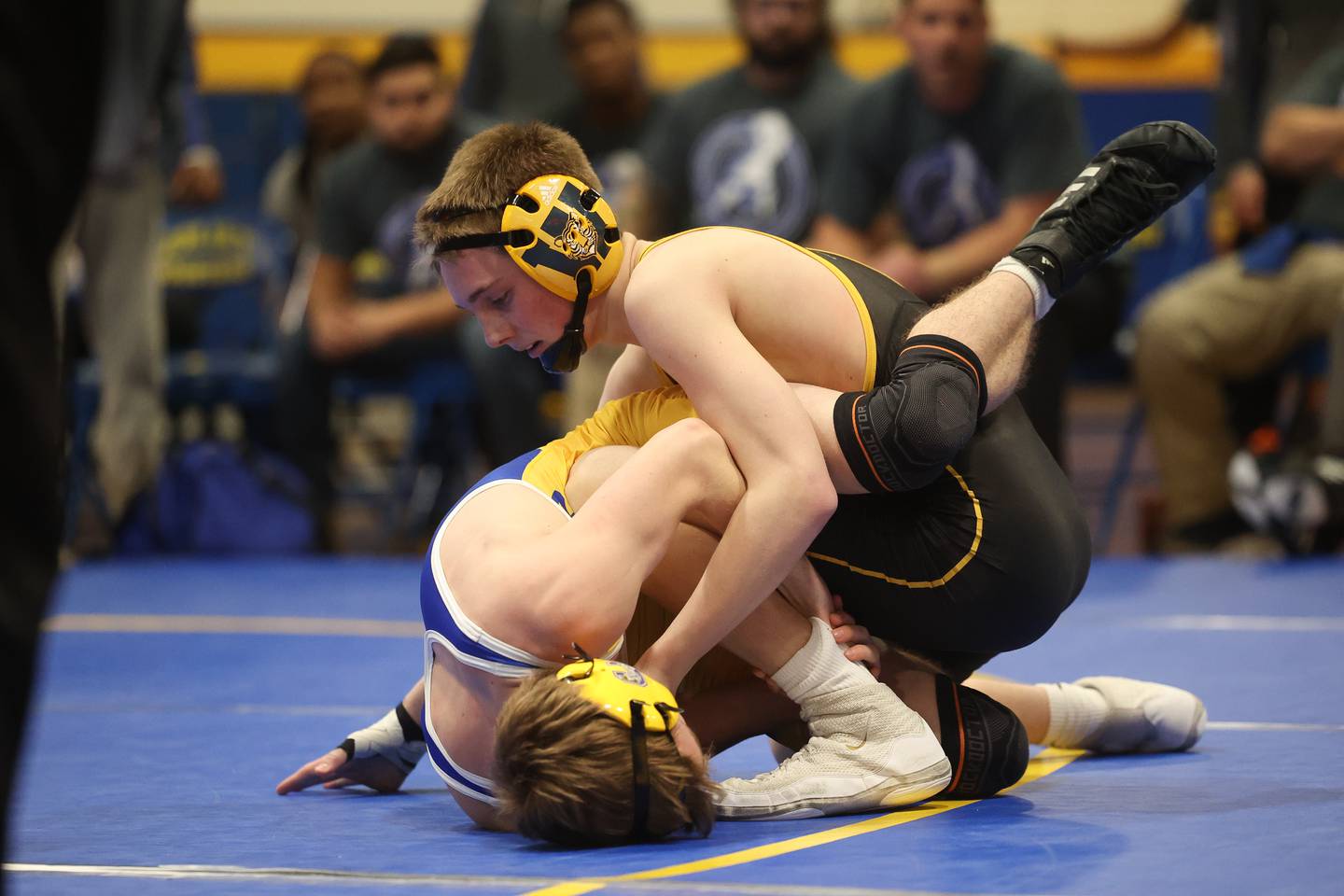 Joliet West’s Jakob Crandall rolls Joliet  Central’s Liam Walsh in the 113-pound weight match at Joliet Central on Friday, Jan 31, 2025.