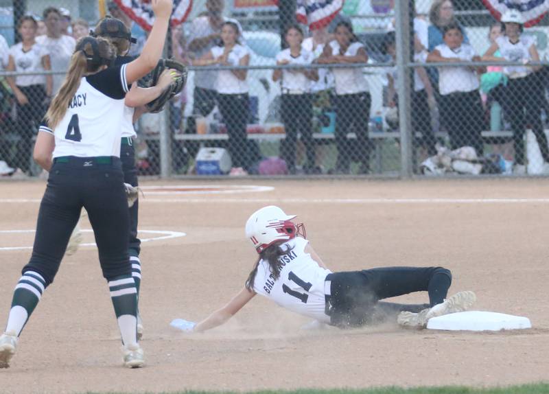 Spring Valley's Reese Baltikauski slides into second base while Evergreen Park's Penelope Tracy waves the throw off during the Minor League Softball State title game on Thursday, July 27, 2023 at St. Mary's Park in La Salle.