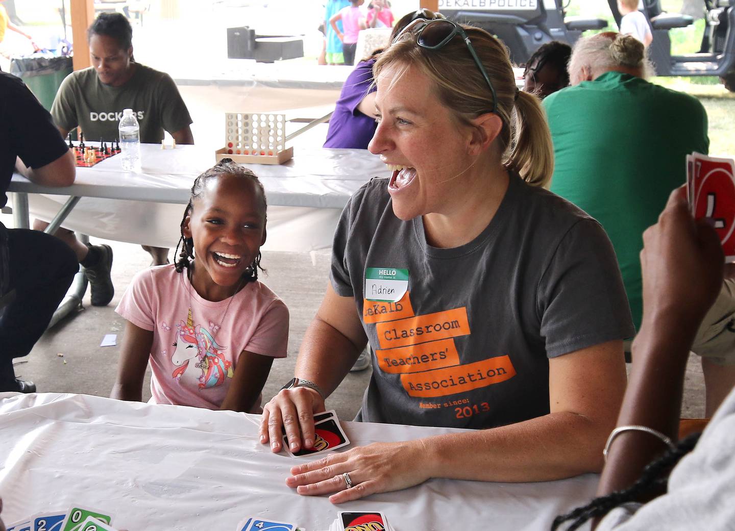 Mariah Cotton, 10, from DeKalb, and volunteer Adrien Fell, also from DeKalb, enjoy a game of Uno during Fun Jam in the Park Tuesday, June 27, 2023, at Welsh Park in DeKalb. Fun Jam in the Park offers constructive activities for kids on Tuesday and Thursday through August 8th from 5-7 p.m. at various parks in DeKalb.