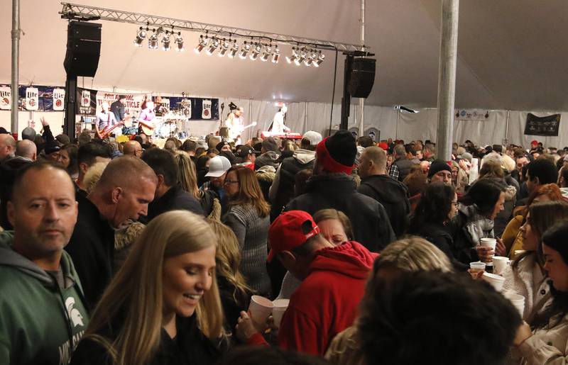 Hundreds pack an outside tent for a performance by Modern Day Romeos during the 39th annual Turkey Testicle Festival at Parkside Pub on Wednesday, Nov. 24, 2021, in Huntley.
